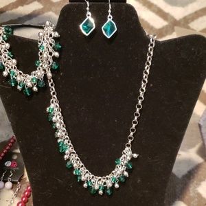 green jeweled earrings, necklace and bracelet